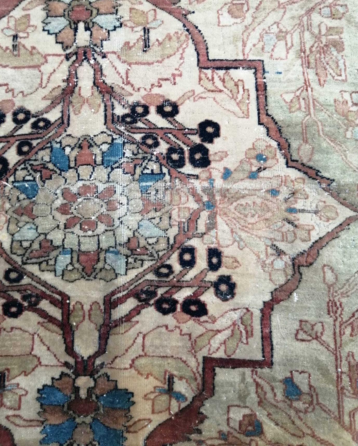 A fine Persian cream ground carpet, in distressed condition, 360 x 300cm